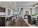 Open-concept kitchen and dining area with dark wood cabinets, stainless steel appliances, and barstool seating at 867 Peachtree Ne St # 702, Atlanta, GA 30308