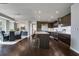 Open concept kitchen featuring dark wood cabinetry, stainless steel appliances, and barstool seating at island at 867 Peachtree Ne St # 702, Atlanta, GA 30308