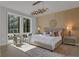Comfortable main bedroom features plush bedding, contemporary light fixture and large windows at 867 Peachtree Ne St # 702, Atlanta, GA 30308