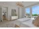 Bright main bedroom with large windows, comfortable bed, and stylish modern light fixture at 867 Peachtree Ne St # 702, Atlanta, GA 30308