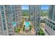 Stunning rooftop pool surrounded by lush greenery and modern high-rise buildings at 867 Peachtree Ne St # 702, Atlanta, GA 30308