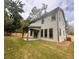 Backyard with covered patio and large windows offering natural light to the interior at 1679 Eastside Parc St, Atlanta, GA 30316