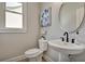Powder room featuring pedestal sink, round mirror, and grey walls at 1679 Eastside Parc St, Atlanta, GA 30316