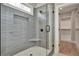 Modern bathroom featuring a glass shower with gray tile and a built-in seat and next to a bright, walk-in closet at 1679 Eastside Parc St, Atlanta, GA 30316