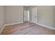 Neutral bedroom featuring hardwood floors and two bright white doors, offers a clean and modern aesthetic at 1679 Eastside Parc St, Atlanta, GA 30316