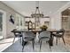 Open-concept dining area with modern lighting and an adjacent kitchen featuring sleek white cabinetry at 1679 Eastside Parc St, Atlanta, GA 30316