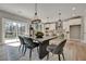 Dining area adjacent to the kitchen, featuring modern chairs, a contemporary light, and a sliding glass door at 1679 Eastside Parc St, Atlanta, GA 30316