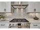 Beautiful kitchen with stainless steel range, stylish herringbone backsplash and modern cabinetry at 1679 Eastside Parc St, Atlanta, GA 30316