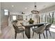 Bright open-concept living room with stylish dining table and access to the backyard at 1679 Eastside Parc St, Atlanta, GA 30316