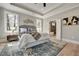 Spacious main bedroom with a view into the ensuite bathroom and hardwood floors at 1679 Eastside Parc St, Atlanta, GA 30316