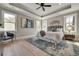 Bright main bedroom featuring tray ceiling, large windows, and hardwood floors at 1679 Eastside Parc St, Atlanta, GA 30316