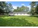 The backyard boasts a large, well-kept lawn under a sunny sky at 1799 Harmony Rd, Powder Springs, GA 30127