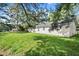 The backyard features a sprawling green lawn with mature trees at 1799 Harmony Rd, Powder Springs, GA 30127