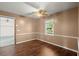 Comfortable bedroom featuring wood flooring, a ceiling fan, and a window for natural light at 1799 Harmony Rd, Powder Springs, GA 30127