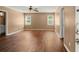 Spacious bedroom featuring wood floors and natural light from two windows that enhance an inviting atmosphere at 1799 Harmony Rd, Powder Springs, GA 30127