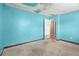 Bedroom with blue accent wall, ceiling fan, and neutral door at 1799 Harmony Rd, Powder Springs, GA 30127