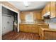 Functional kitchen featuring wooden cabinets, a tiled backsplash, and a laundry area for added convenience at 1799 Harmony Rd, Powder Springs, GA 30127