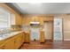 Kitchen featuring a sink with wooden cabinetry, laminate countertops, and tiled backsplash, great space to make meals at 1799 Harmony Rd, Powder Springs, GA 30127