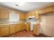 Kitchen featuring a sink with wooden cabinetry, laminate countertops, and tiled backsplash, great space to make meals at 1799 Harmony Rd, Powder Springs, GA 30127
