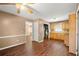 Open-concept living area featuring wood floors that connect to the kitchen, laundry and other living spaces at 1799 Harmony Rd, Powder Springs, GA 30127