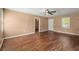 Bright living room featuring hardwood floors, ceiling fan, and natural light at 1799 Harmony Rd, Powder Springs, GA 30127