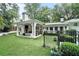 Expansive backyard with lush landscaping, a covered patio, and a black fence at 3089 Marne Nw Dr, Atlanta, GA 30305