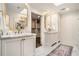 Elegant bathroom featuring marble countertops, double sinks, gold fixtures, and a walk-in closet at 3089 Marne Nw Dr, Atlanta, GA 30305