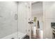 Elegant bathroom features a glass shower with marble tile and contrasting dark herringbone tile floor at 3089 Marne Nw Dr, Atlanta, GA 30305