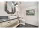 Chic bathroom with a vessel sink, decorative mirror, and herringbone tile flooring at 3089 Marne Nw Dr, Atlanta, GA 30305