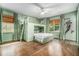 Charming green bedroom with a bunk bed, built-in shelves, and natural light from two windows at 3089 Marne Nw Dr, Atlanta, GA 30305