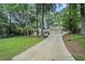 Charming traditional-style home features a long driveway and well-manicured lawn at 3089 Marne Nw Dr, Atlanta, GA 30305