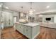 Bright kitchen with a large island, pendant lighting, and open access to the living room at 3089 Marne Nw Dr, Atlanta, GA 30305