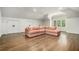 Spacious living area boasts hardwood floors, shiplap walls, and an oversized pink sectional couch at 3089 Marne Nw Dr, Atlanta, GA 30305