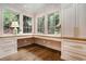 Bright office featuring custom built-in desk, cabinets, drawers, and large windows at 3089 Marne Nw Dr, Atlanta, GA 30305