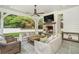 Inviting outdoor patio featuring a brick fireplace, comfortable seating, and a ceiling fan at 3089 Marne Nw Dr, Atlanta, GA 30305