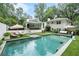 Stunning backyard pool and patio area with lounge chairs, sofa, and manicured lawn at 3089 Marne Nw Dr, Atlanta, GA 30305