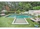Luxurious backyard featuring a large pool, manicured lawn, lounge chairs, and mature trees at 3089 Marne Nw Dr, Atlanta, GA 30305