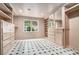 Well-organized walk-in closet with built-in shelving, drawers, and a patterned tile floor at 3089 Marne Nw Dr, Atlanta, GA 30305