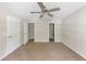 Main bedroom with plush carpeting, ceiling fan, and two closets at 400 Rustin Dr, Dallas, GA 30157