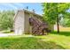 View of house with back porch, basement and garage, plus a fenced-in yard at 400 Rustin Dr, Dallas, GA 30157