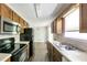 Kitchen featuring wood cabinets and stainless-steel appliances and a view to eat-in area at 400 Rustin Dr, Dallas, GA 30157