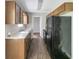 Galley kitchen with black appliances, wood cabinets, and laminate countertops at 400 Rustin Dr, Dallas, GA 30157