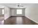 Bright living room features wood floors, a ceiling fan, and natural light at 400 Rustin Dr, Dallas, GA 30157