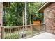 Outdoor patio with privacy fencing surrounded by lush greenery and shade trees at 800 Old Plank Sq, Duluth, GA 30097
