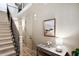 Elegant foyer with staircase, hardwood floors, and stylish console table with artwork at 800 Old Plank Sq, Duluth, GA 30097