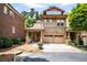 Charming two-story home with a brick and tan exterior and a two-car garage at 800 Old Plank Sq, Duluth, GA 30097