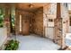 Inviting covered porch featuring brick columns and a stylish front door with sidelights at 800 Old Plank Sq, Duluth, GA 30097