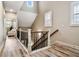 Upstairs hallway featuring wood floors, iron railing, and natural light at 800 Old Plank Sq, Duluth, GA 30097