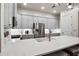 Bright kitchen features white countertops, stainless steel appliances, and a large center island at 800 Old Plank Sq, Duluth, GA 30097