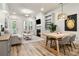 Cozy living area with fireplace, built-in shelving, and dining table near natural light at 800 Old Plank Sq, Duluth, GA 30097